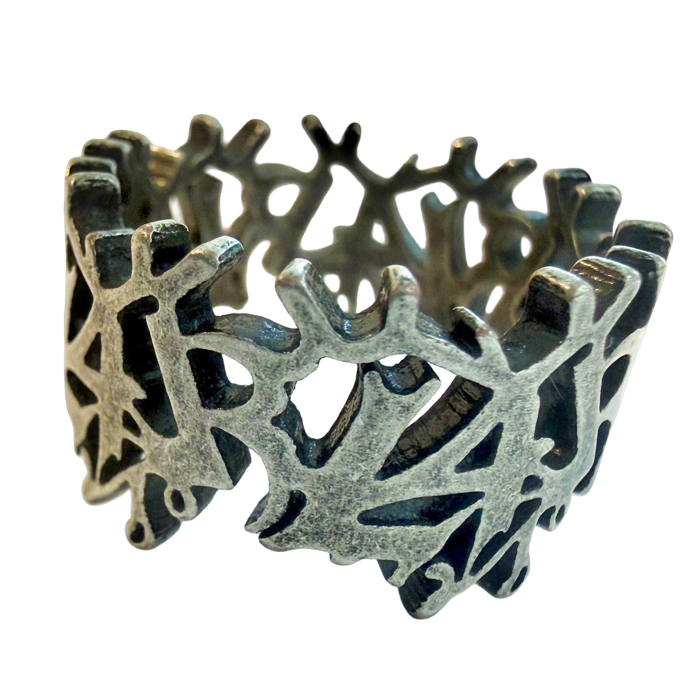 Silver L4L logo wrapped ring with intricate design on a white background